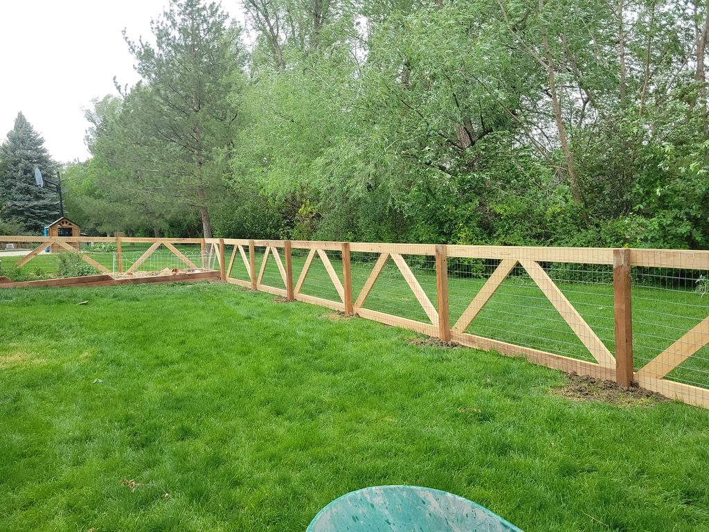 Wood and wire fence installation with custom gate