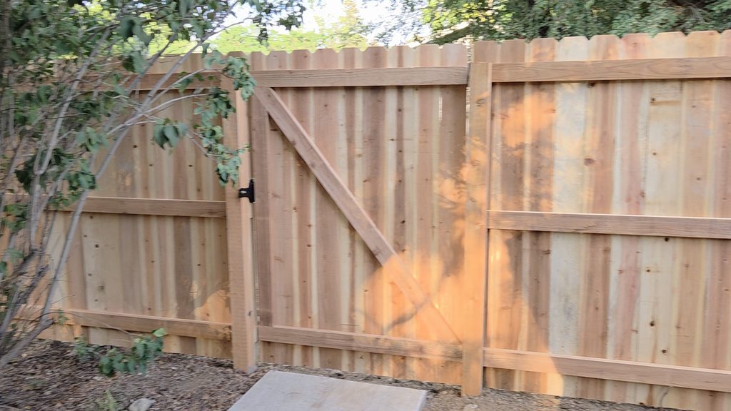 Wood privacy fence with custom gate